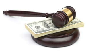 Law gavel on a stack of American money.